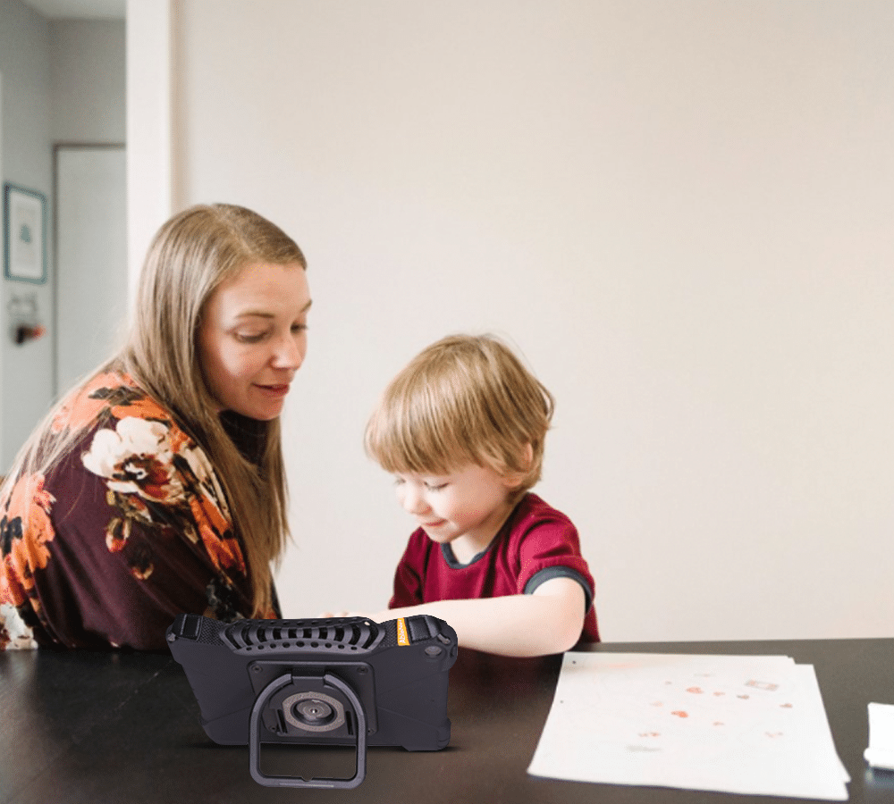 Mother and child enjoying creative art time together with colorful drawings and a QuickTalker Freestyle AAC device.