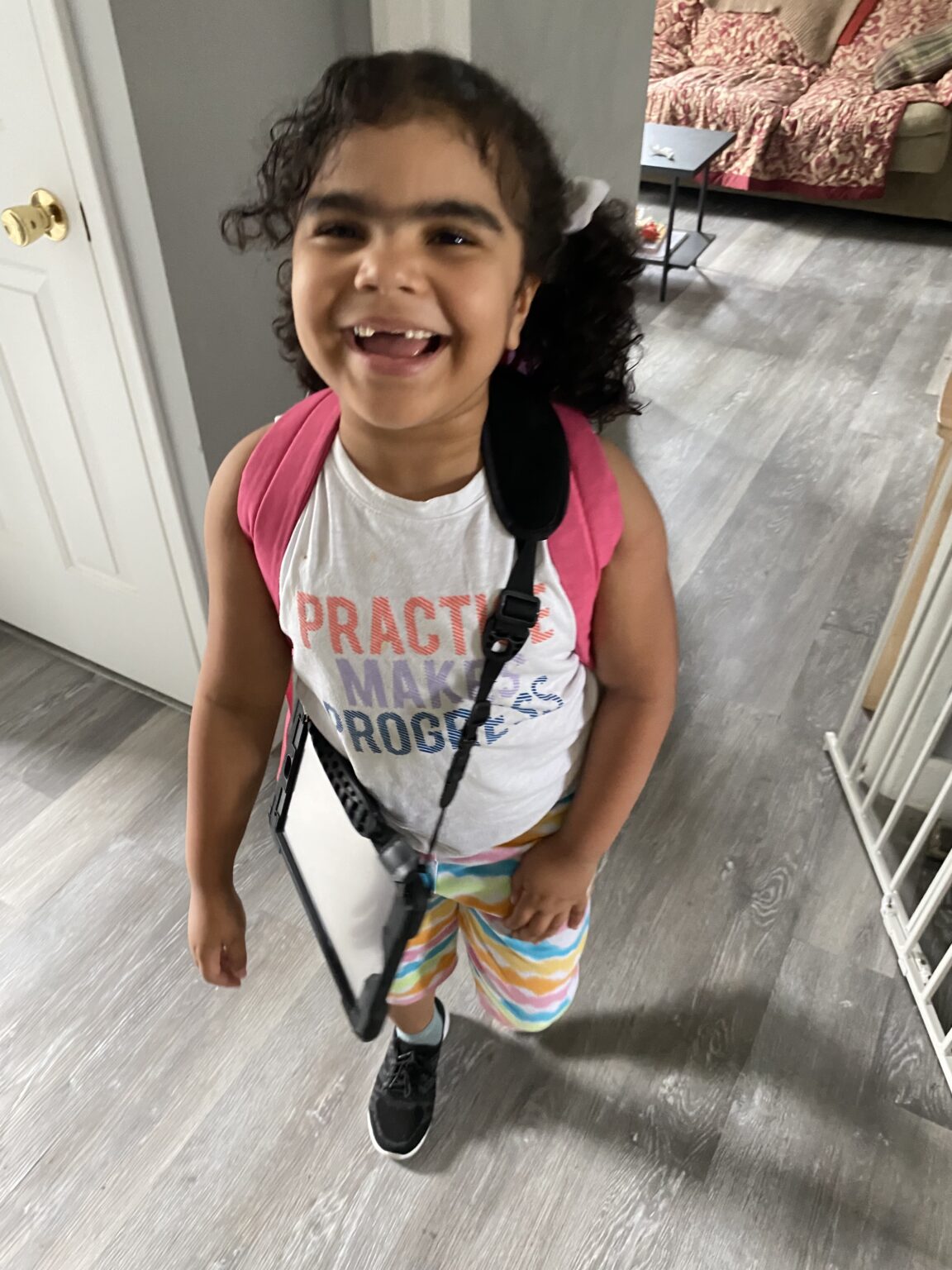 Joyful child with backpack, excited for outdoor adventures and exploration.