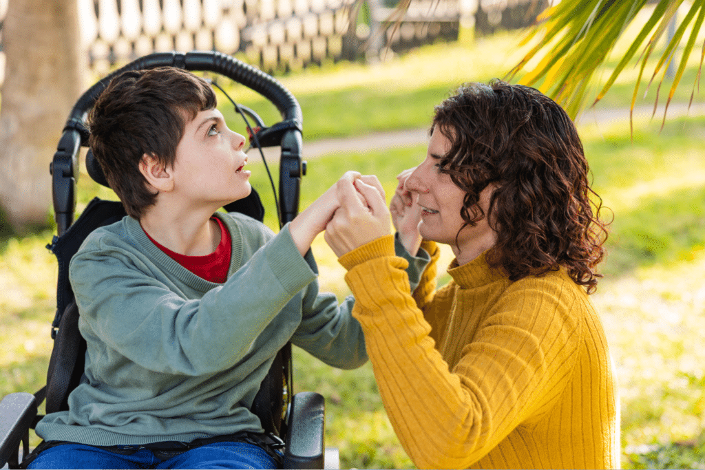 Mother and son share a loving moment of connection and support outdoors.