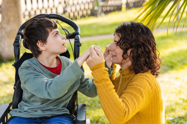 Mother and son share a loving moment of connection and support outdoors.