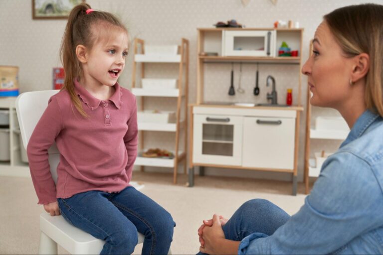 Child and adult engaged in a meaningful conversation in a cozy room setting.
