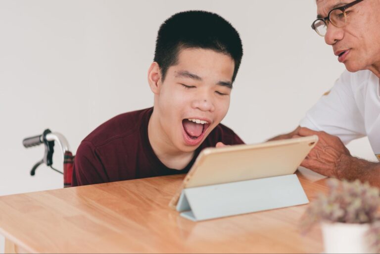 Child joyfully learning with a tablet, engaged and smiling during interaction.