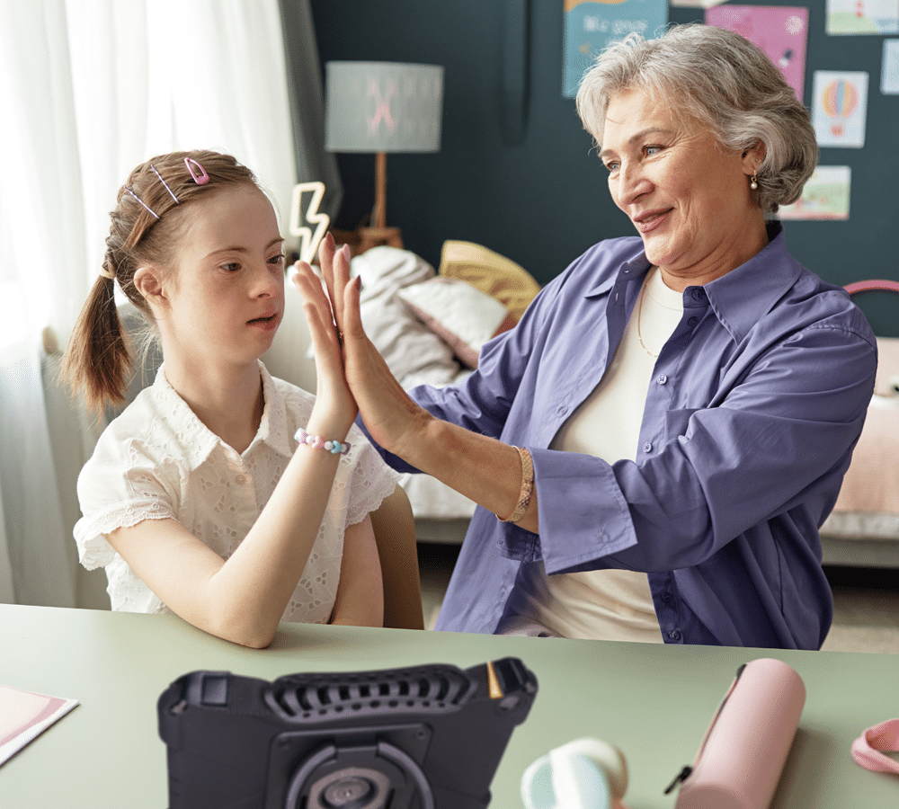 Generational bonding between a grandmother and granddaughter during a joyful interaction.