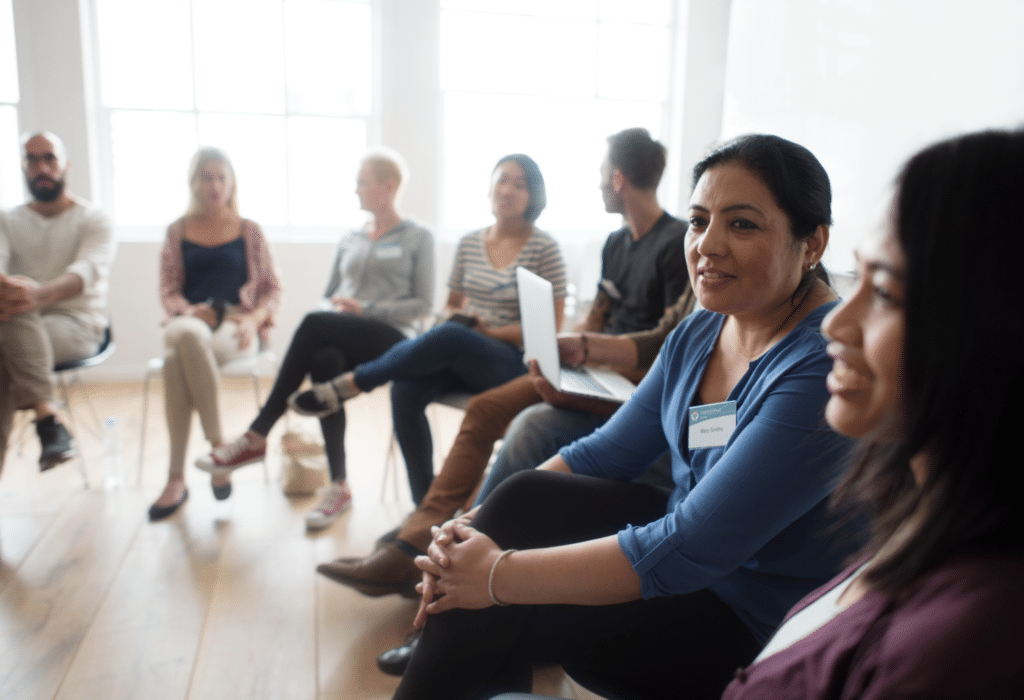 Diverse group engaging in lively discussion in a bright, collaborative webinar