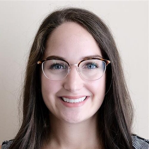 Happy woman smiling in glasses, showcasing confidence and joy.