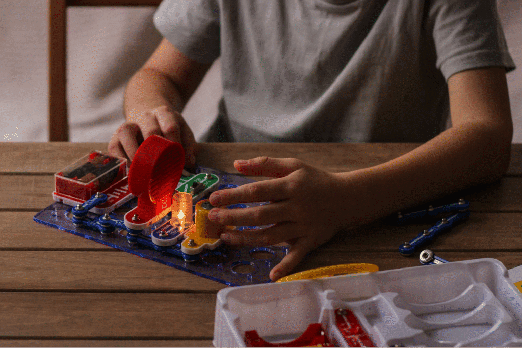 child playing with cause and effect toy