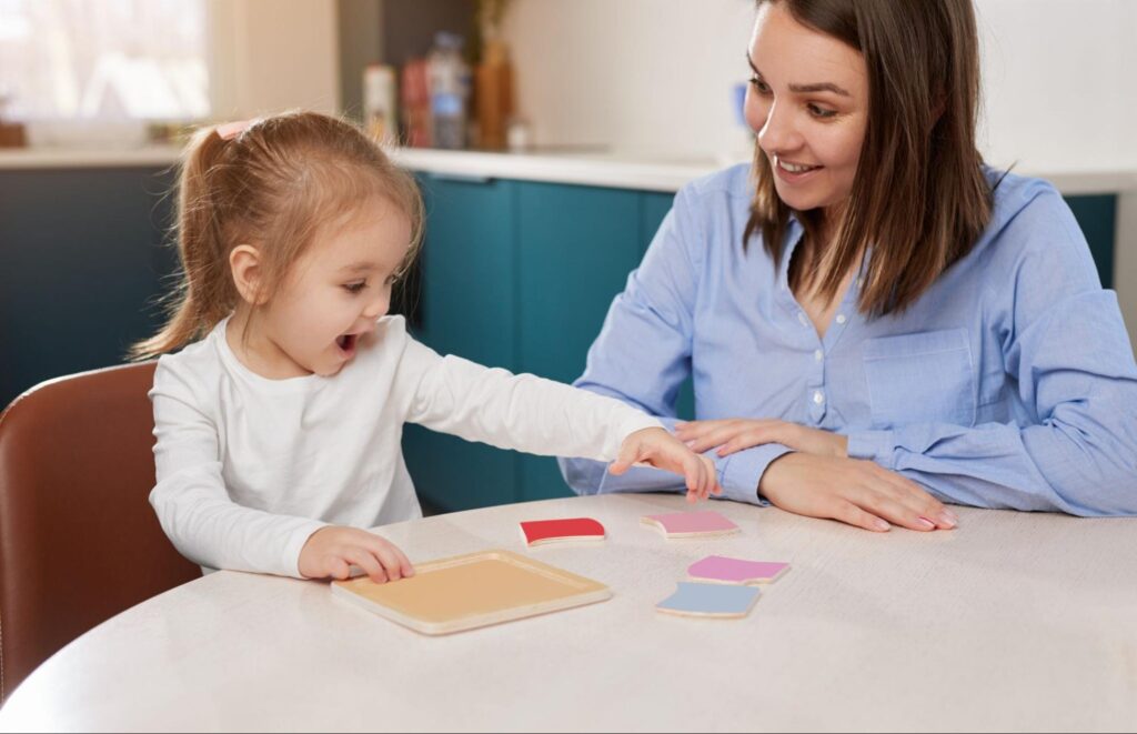 Mother and daughter enjoying a fun learning activity with colorful cards at home.