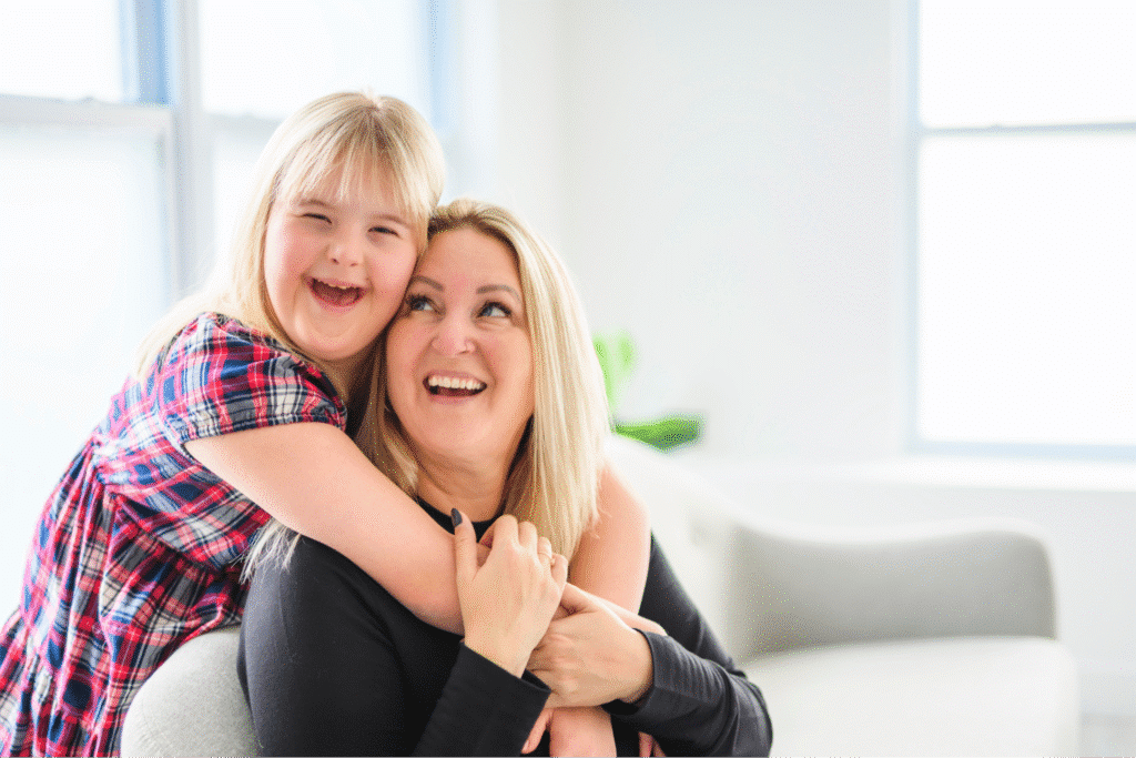Happy mother and daughter sharing a joyful moment in a bright living room.
