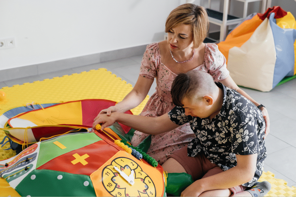 A mother and child engage in playful learning with colorful activity mats.