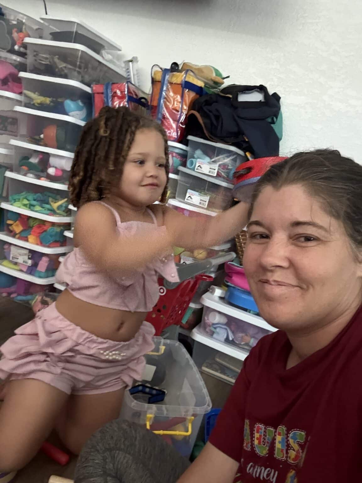 Mom and daughter enjoy creative playtime with toys and laughter at home.