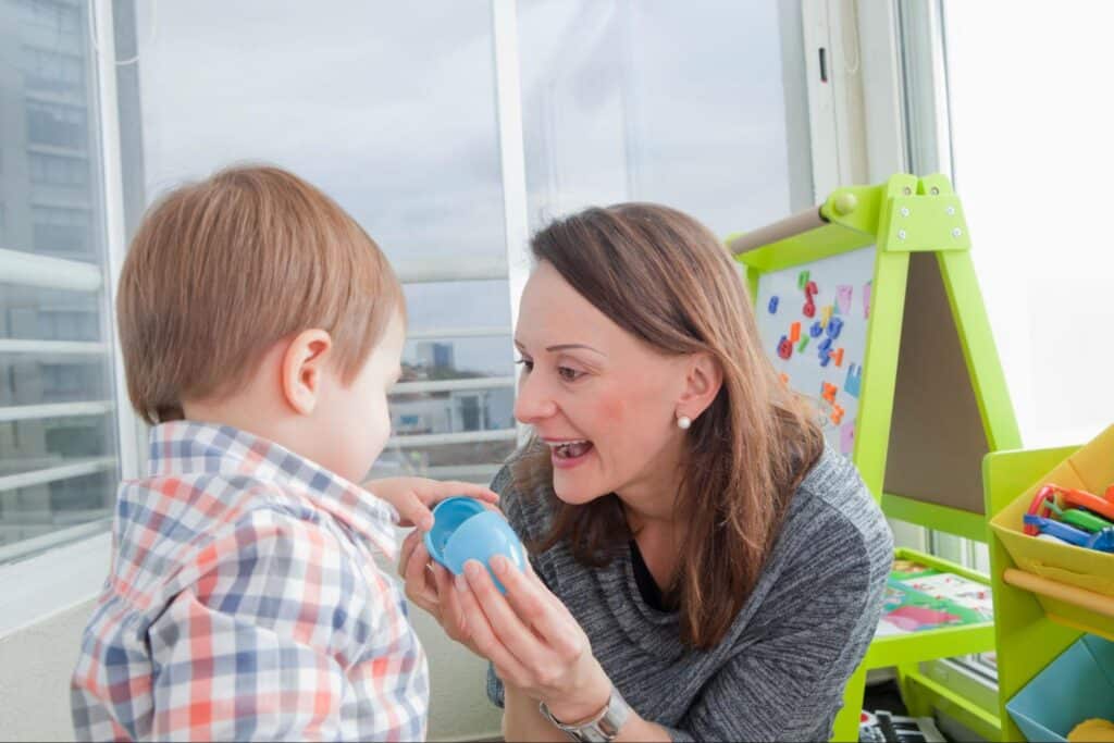 Mother and child enjoying playtime with colorful toys indoors.