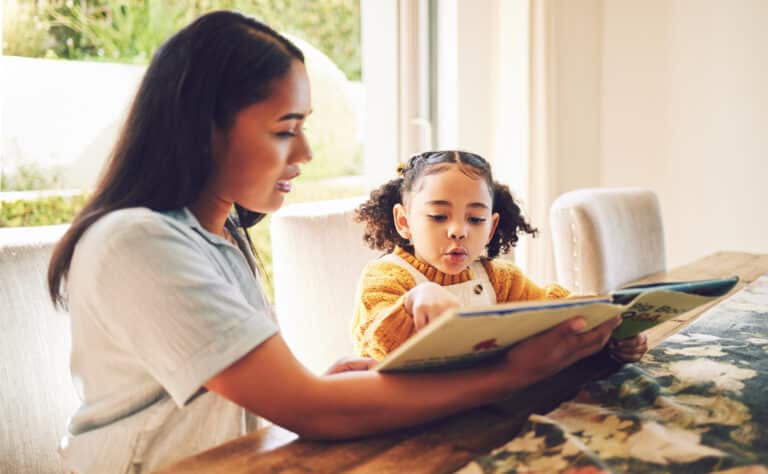 Mom and daughter enjoy reading together, fostering literacy and education at home.