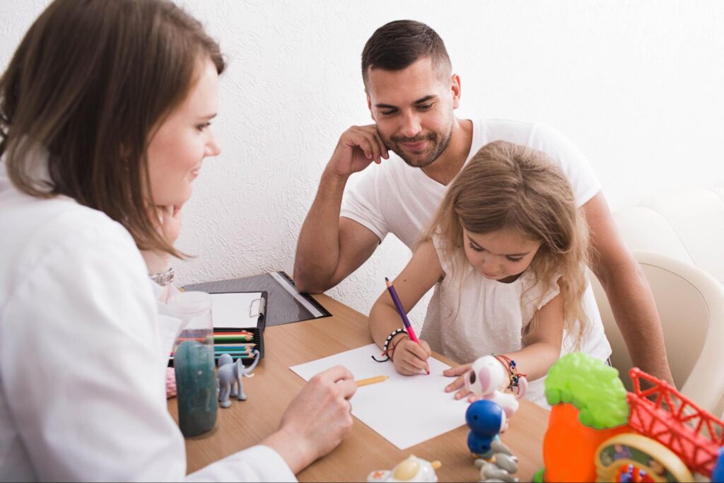 Parent and child enjoy creative art therapy in a colorful classroom setting.