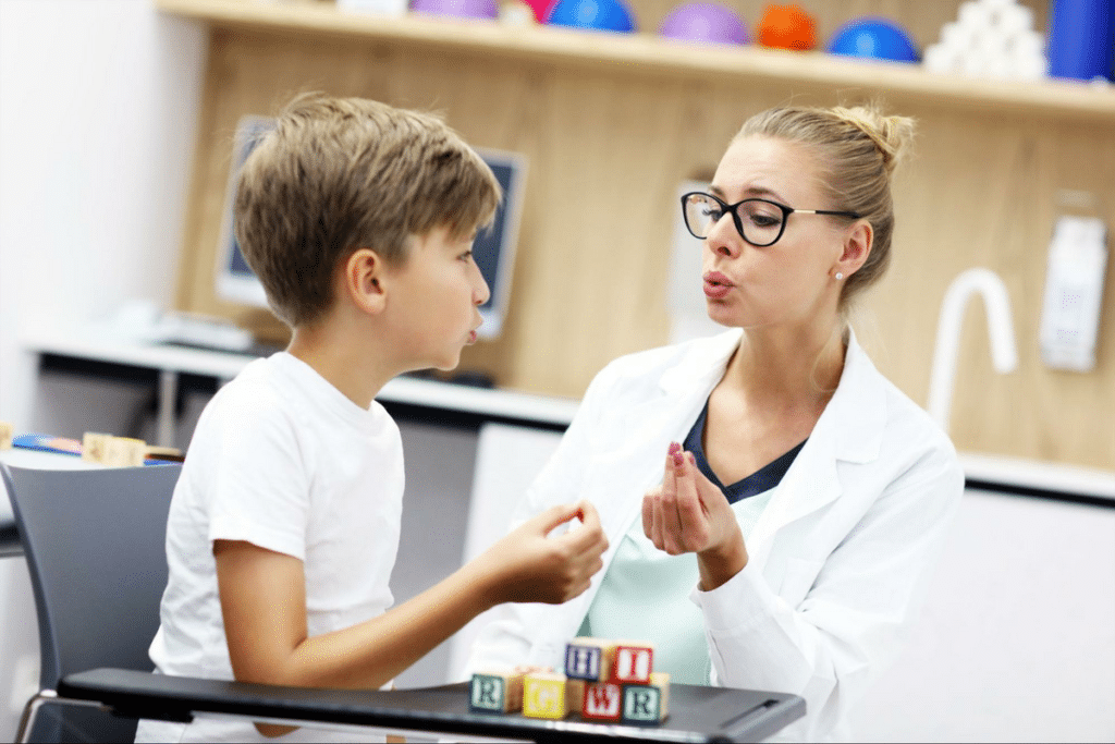 Child and therapist engage in playful learning during a therapeutic session.