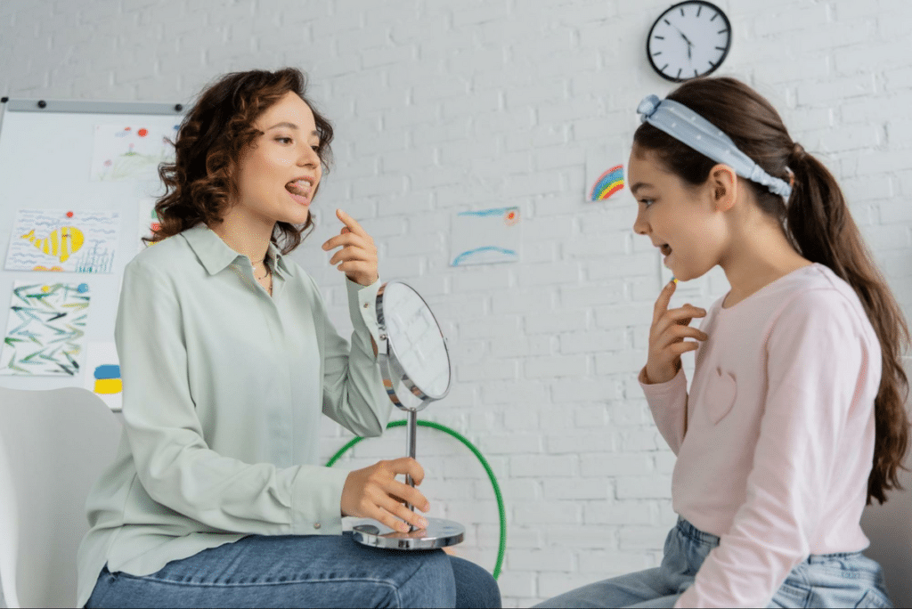Child and therapist practicing speech therapy to improve communication skills together.