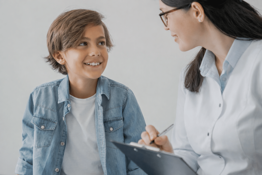 Child enjoying speech therapy with a speech-language pathologist in a supportive setting.