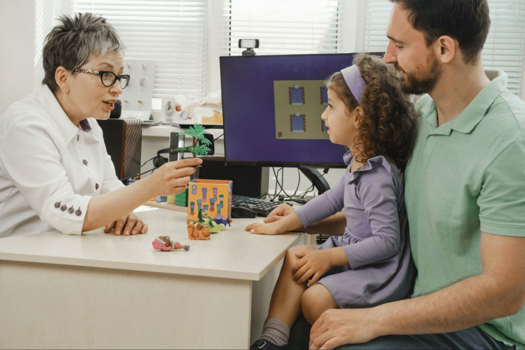 Therapist uses play to engage child and parent in family therapy session.