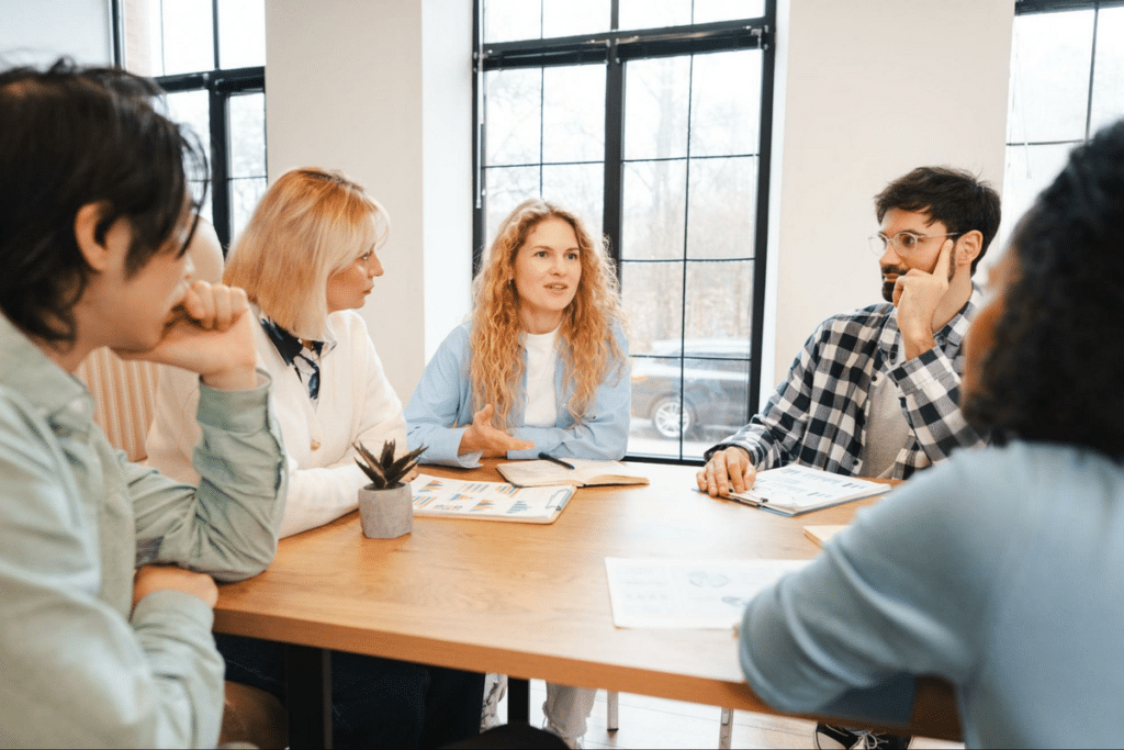 Team brainstorming in a bright, modern workspace, fostering creativity and collaboration.