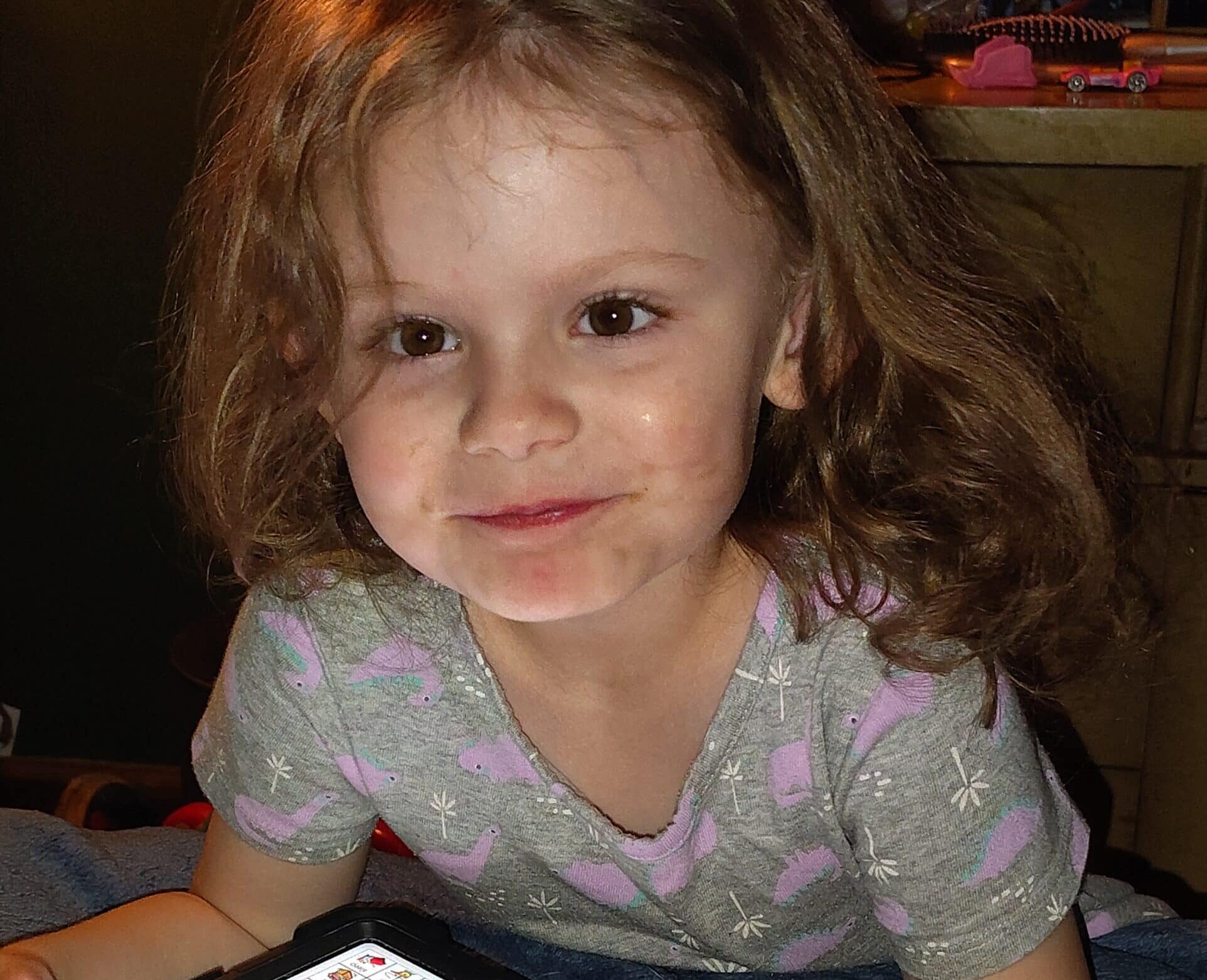 Child engages with a tablet, showcasing technology use in able families.
