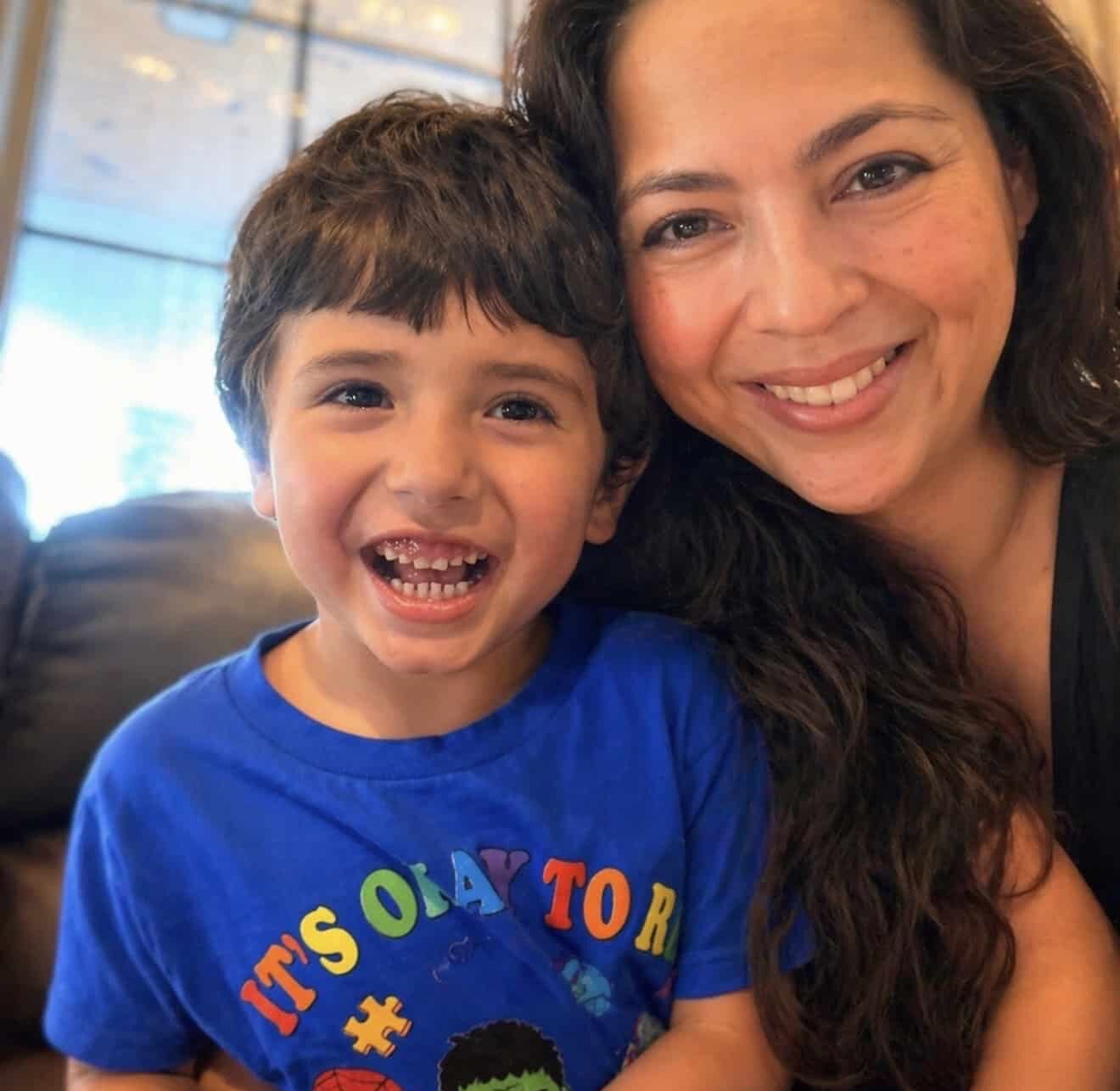 Joyful mother and child smile together, celebrating happy family moments with AbleFamilies.