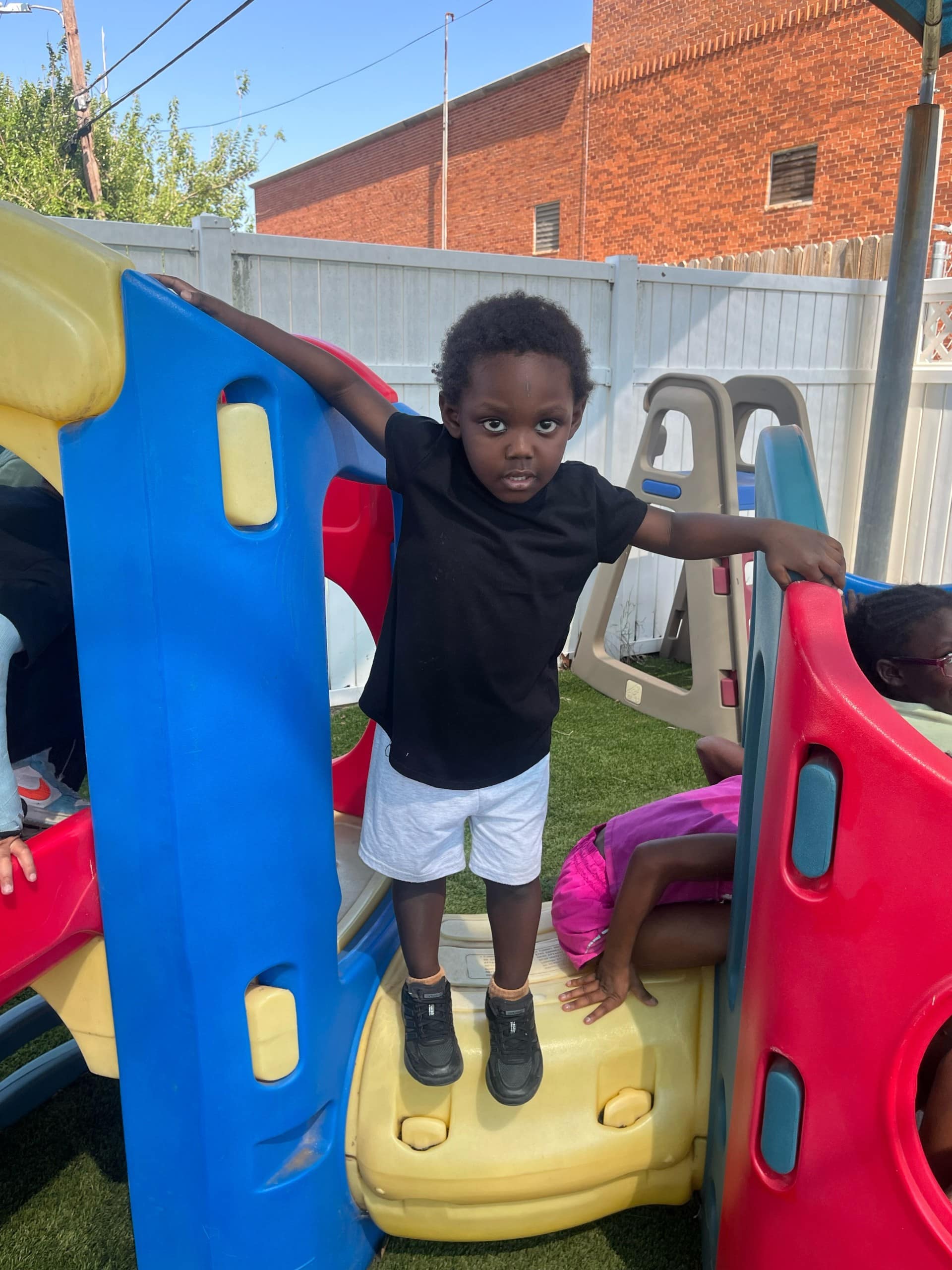 Kids enjoying playground fun with able families in a vibrant outdoor setting.