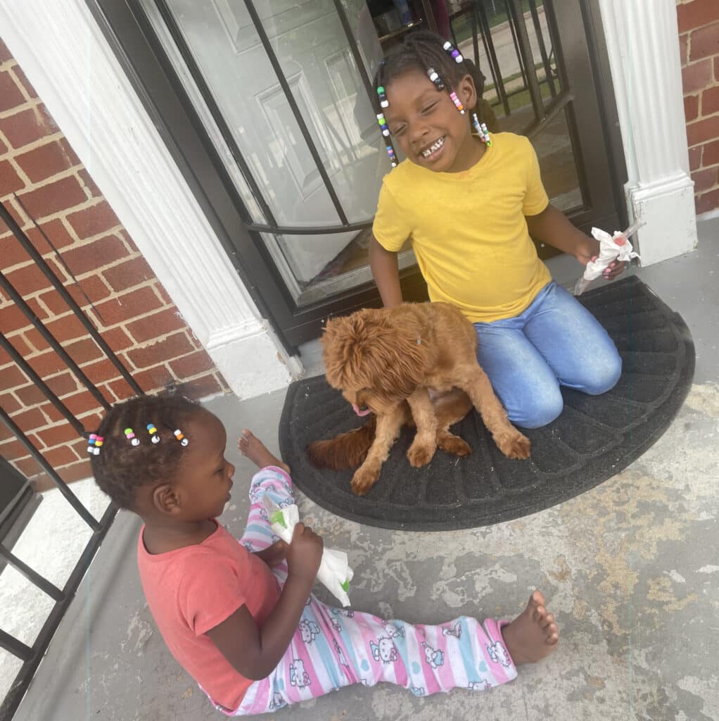 Happy kids enjoy time with their dog, embracing joyful moments with ablefamilies.