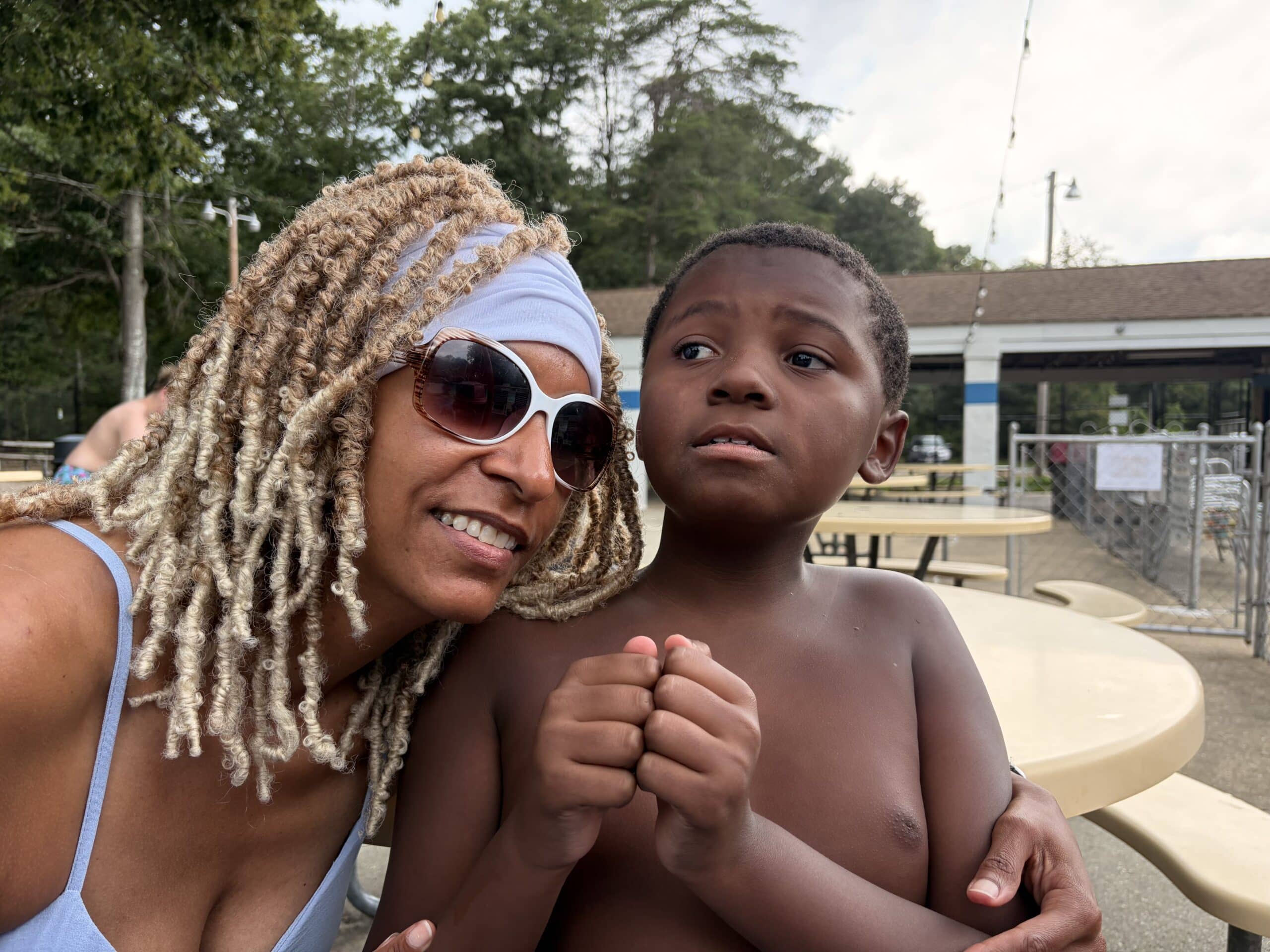 Happy mom and son enjoy quality time at the pool, celebrating able families.