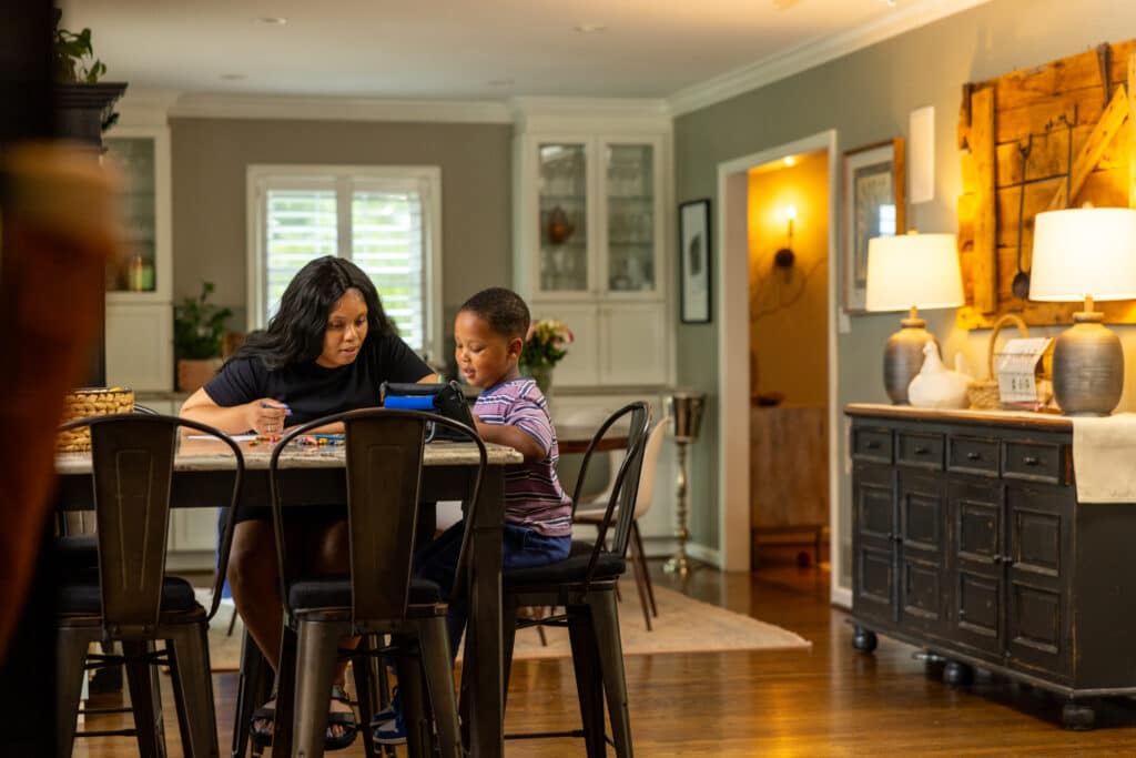 Mother and son cooking together in a warm, inviting kitchen.