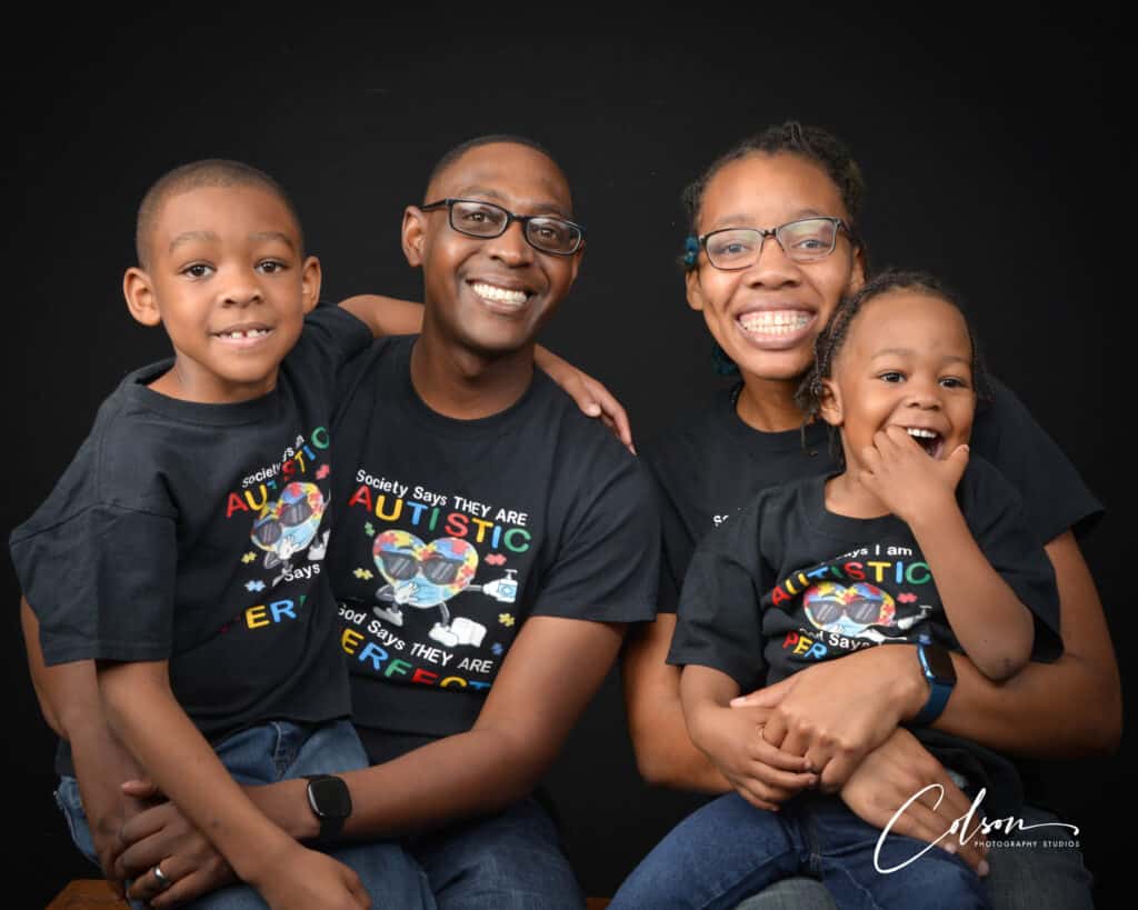 Family celebrating autism awareness in matching shirts, showcasing love and unity.
