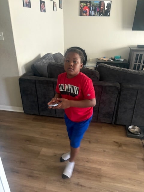 Jayden standing in the living room at home