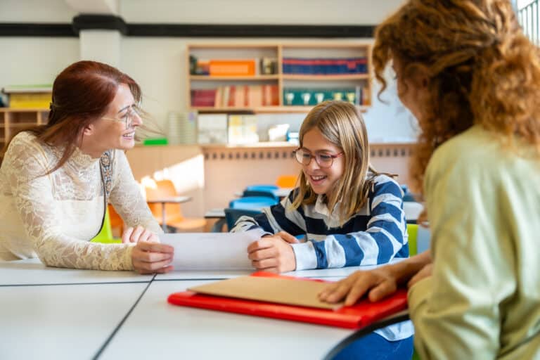 SLP and student engage in interactive learning during a classroom meeting.