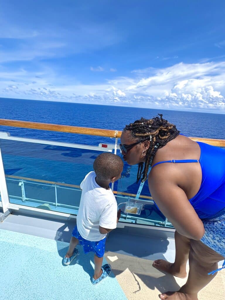 Mother and son share a loving moment by the ocean on a cruise.