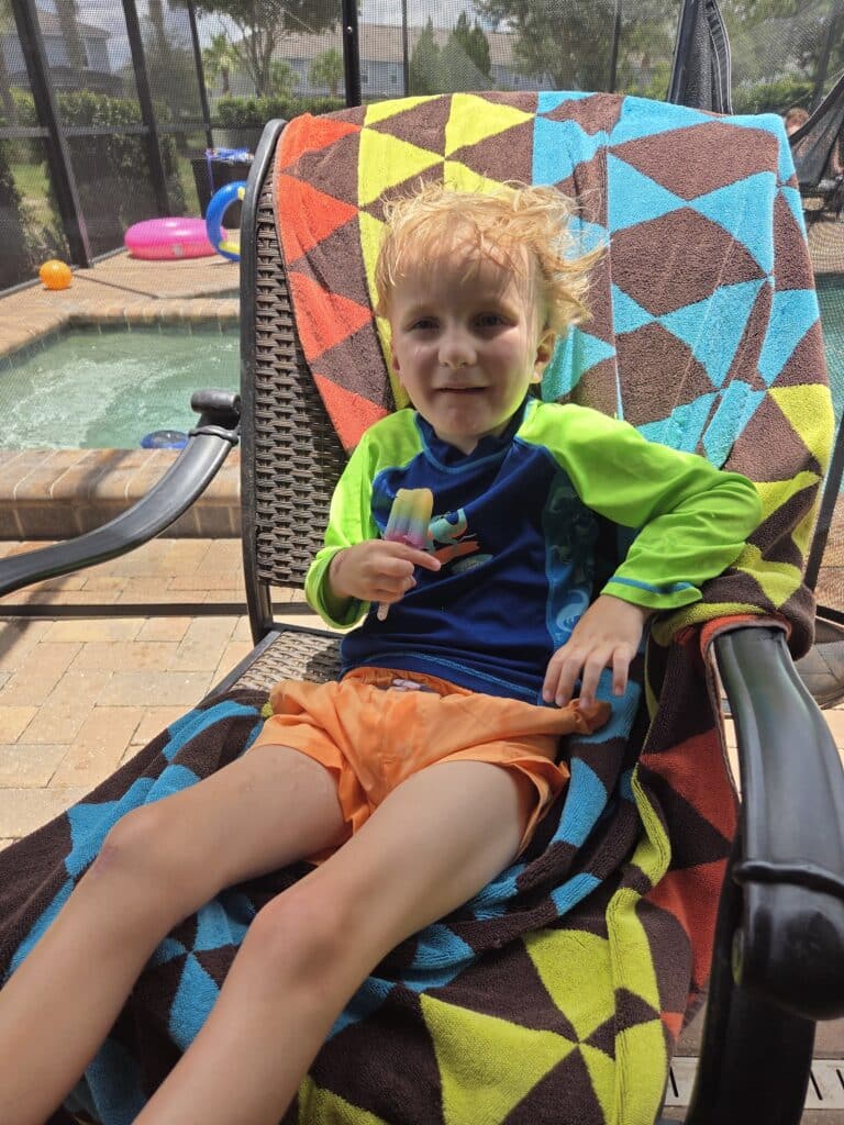 Kids enjoying summer fun with popsicles by the pool, perfect for ablefamilies.
