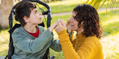 Mother and son share a loving moment of connection and support outdoors.