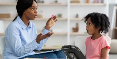 Teacher engages with student about her caseload using interactive techniques.