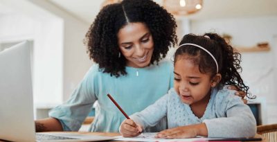 Mother and daughter engaged in creative homework, promoting learning and child development.