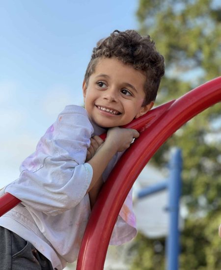 Joyful child playing at the playground, enjoying a sunny day outdoors.