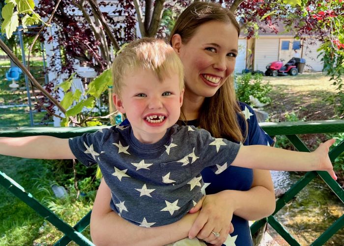 Happy mom and son enjoying a sunny day together, sharing smiles and laughter.