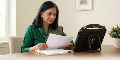 Speech-language pathologist reviewing AAC evaluation notes next to a QuickTalker Freestyle speech device on a desk