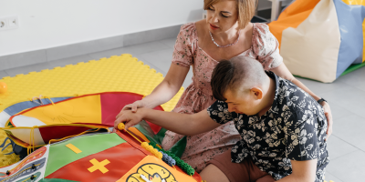 Parents and children enjoying engaging learning activities through playful exploration and interaction.