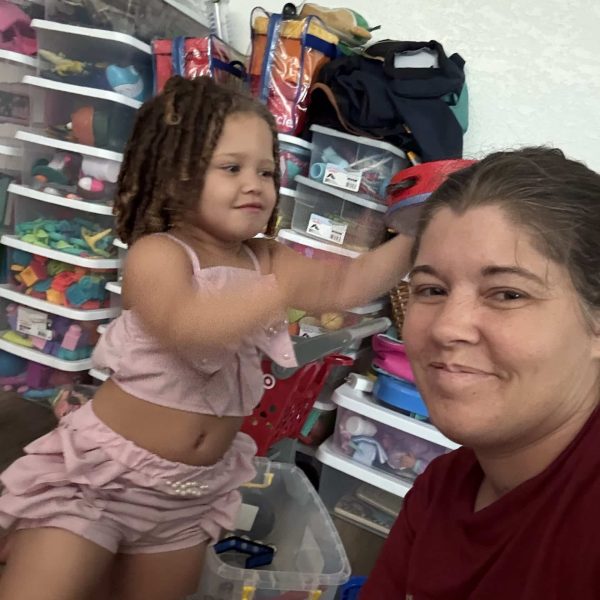 Mom and daughter enjoy creative playtime with toys and laughter at home.