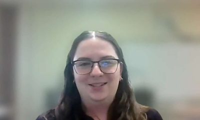 Smiling person with glasses, showcasing joy and positivity in a professional setting.