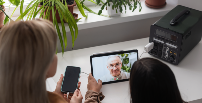 Video call connecting family members with a grandparent, showcasing love and technology.